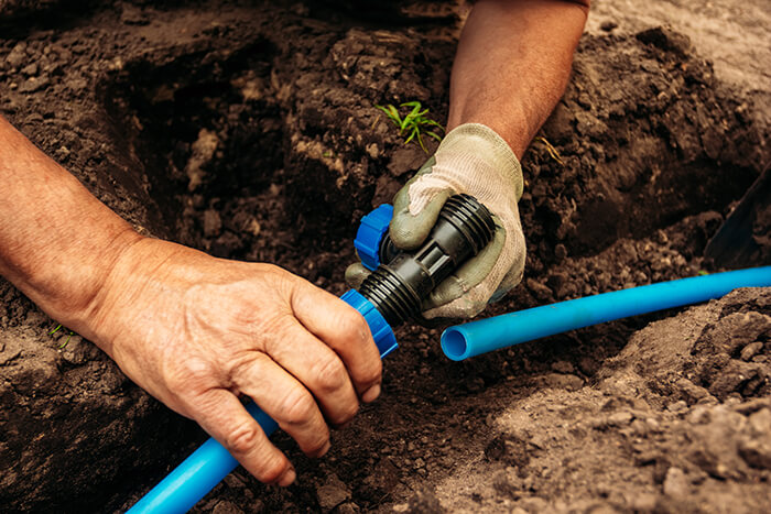 An irrigator working on a sprinkler line