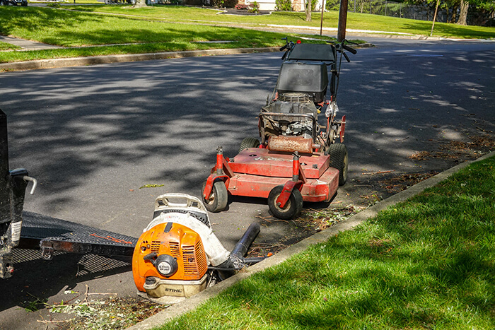 A lawnmower and a leaf blower.